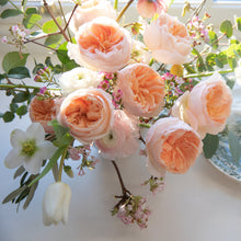A close up of a bouquet of Juliet roses with greenery